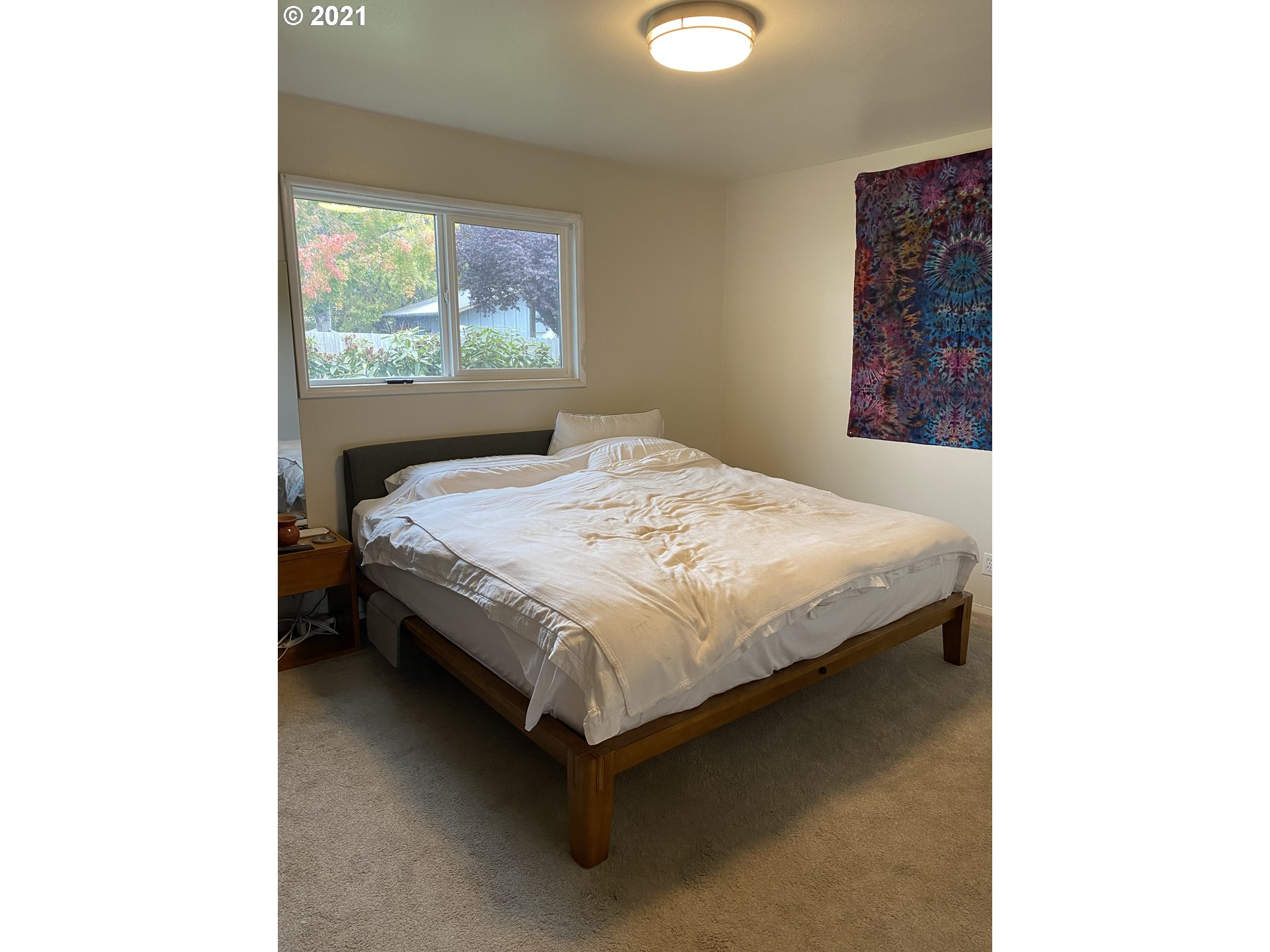 1070 N Street Springfield, OR 97477 - Photo 8 of 14 a bed sitting in a bedroom next to a window
