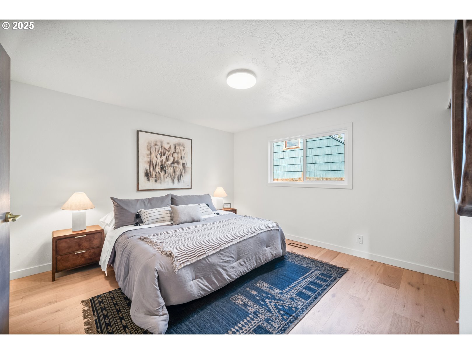 7235 Northeast 9th Avenue Portland, OR 97211 - Photo 16 of 22 a bedroom with a bed and a night stand