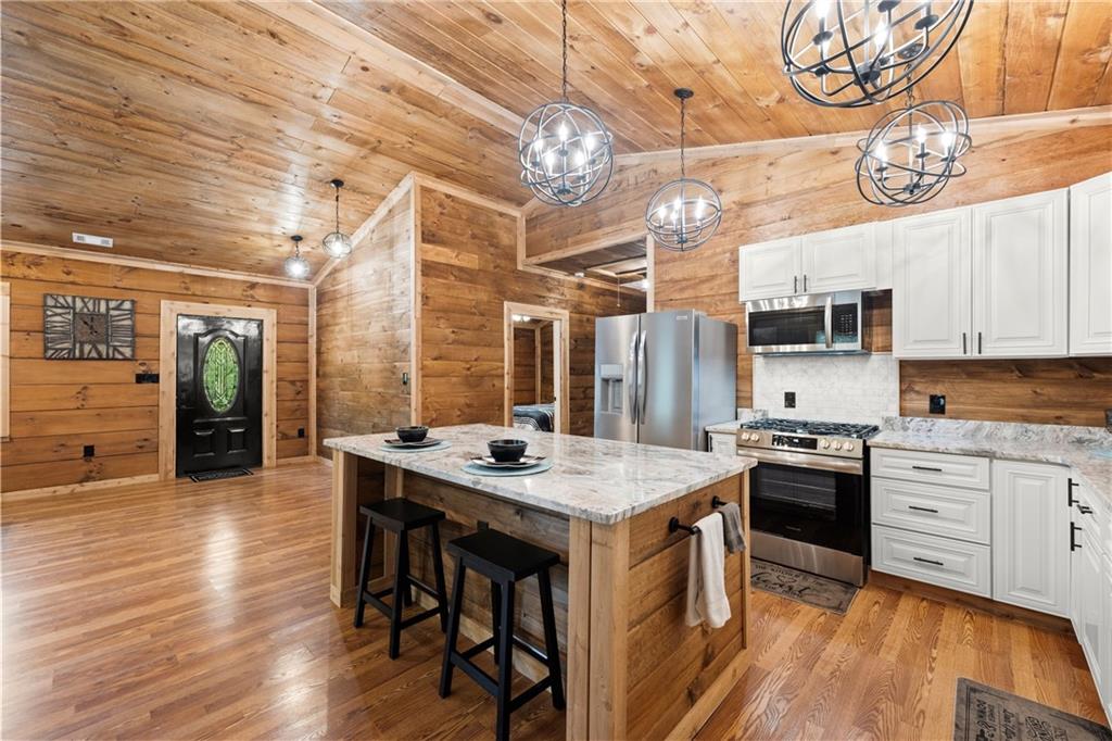 587 Cold Stream Trail Jasper, GA 30143 - Photo 11 of 41 a kitchen with stainless steel appliances granite countertop a sink stove and refrigerator