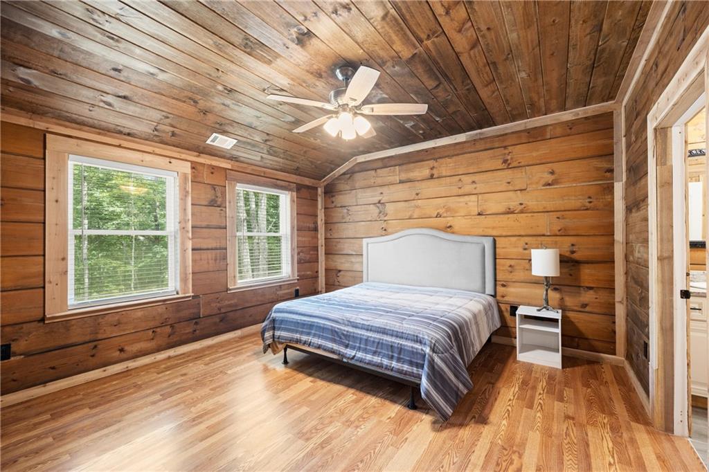 587 Cold Stream Trail Jasper, GA 30143 - Photo 20 of 41 a spacious bedroom with a bed and a large window with balcony view