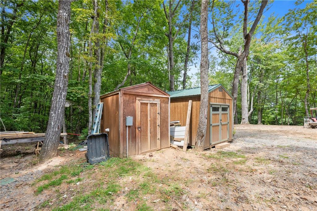 587 Cold Stream Trail Jasper, GA 30143 - Photo 36 of 41 a view of backyard of house with wooden fence and large trees