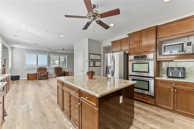 a view of a dining room with furniture a chandelier and wooden floor