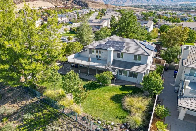 a aerial view of a house with a yard and potted plants