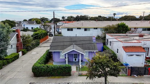 an aerial view of a residential houses with outdoor space and street view