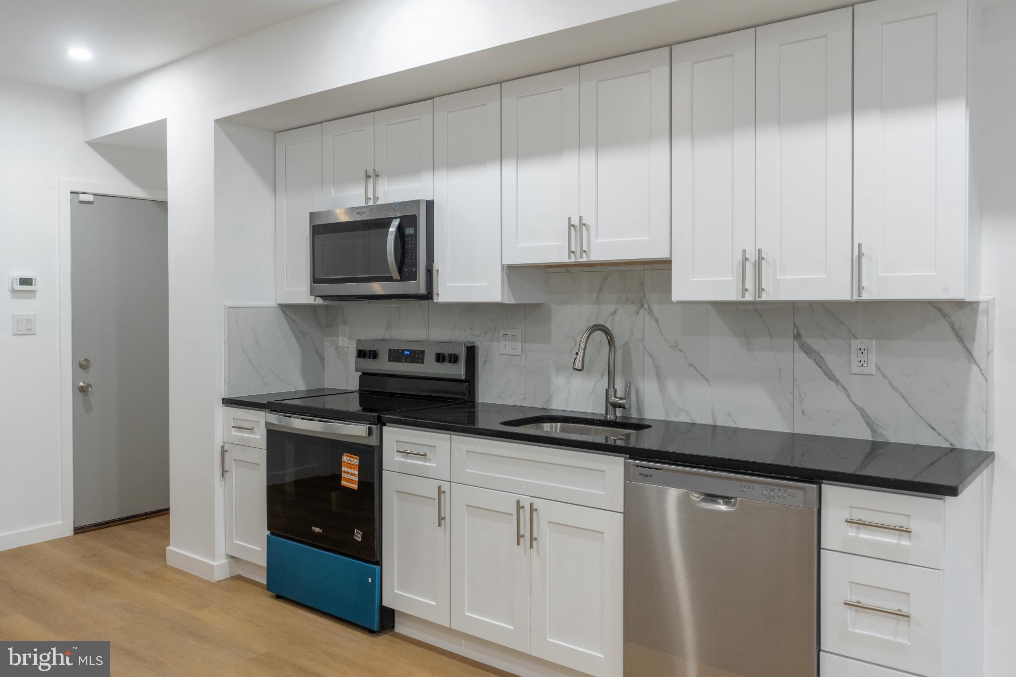 3631 Warren Street Philadelphia, PA 19104 - Photo 7 of 27 Sleek modern kitchen with elegant finishes.