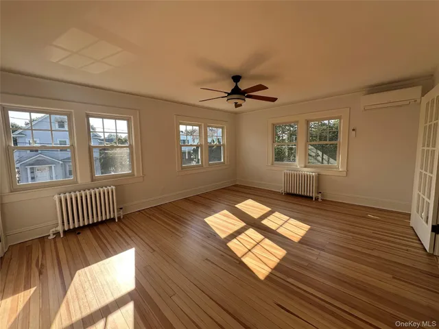 a view of wooden floor and windows in a room