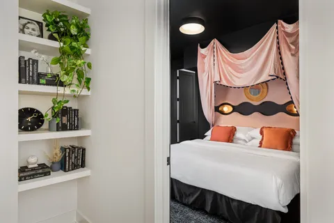a bedroom with a bed and a painting on the wall
