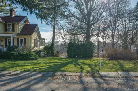 a view of green field with trees in the background