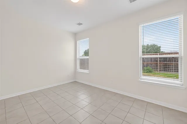 a view of a house with a yard and fence