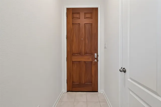 a view of kitchen with stainless steel appliances granite countertop a refrigerator and a stove top oven
