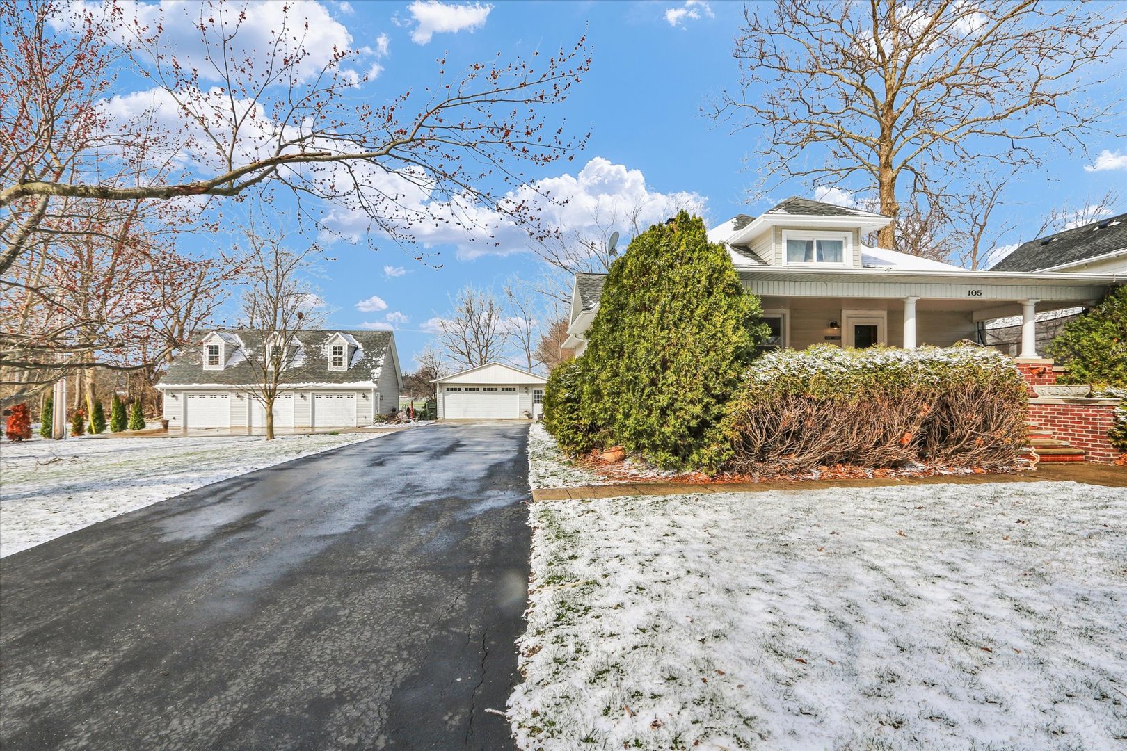 105 South Division Street Mahomet, IL 61853 - Photo 4 of 45 a front view of a house with a yard and garage