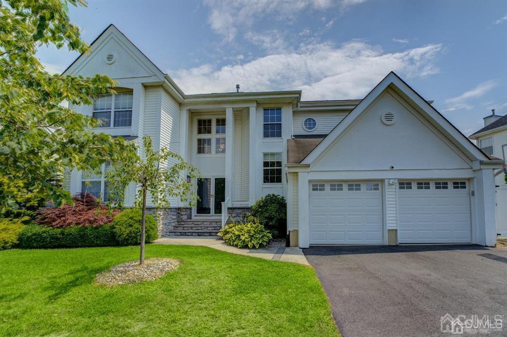 a front view of a house with a yard and garage