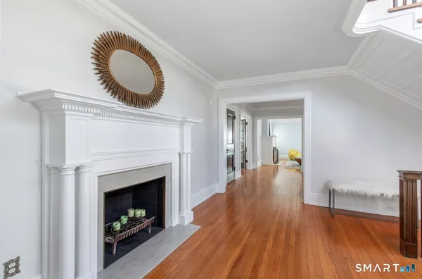 a dining room with a fireplace and a wooden floor
