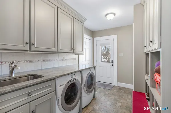 a utility room with sink dryer and washer