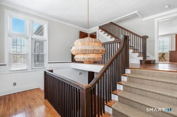 a view of entryway and hall with wooden floor