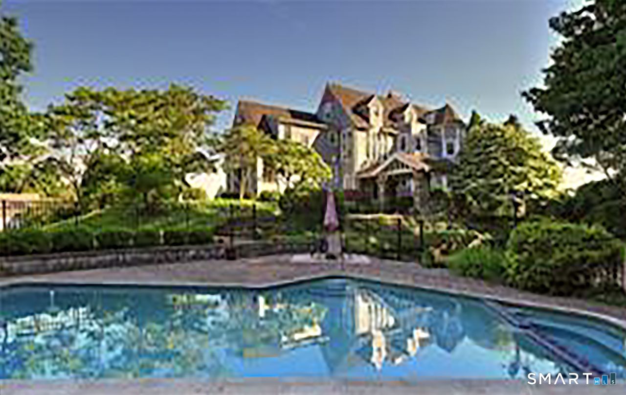 35 Point Lookout Milford, CT 06460 - Photo 2 of 31 A serene backyard retreat featuring a heated gunite pool surrounded by lush landscaping, with the historic estate rising gracefully above perfect for summer relaxation and outdoor entertaining.