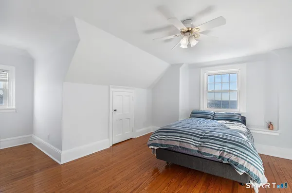 a bedroom with a bed and window