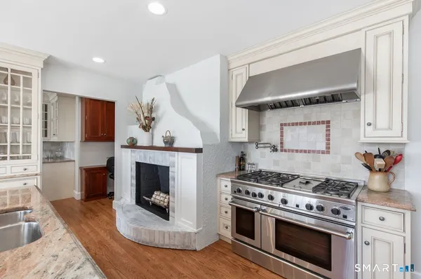 a kitchen with furniture and a fireplace