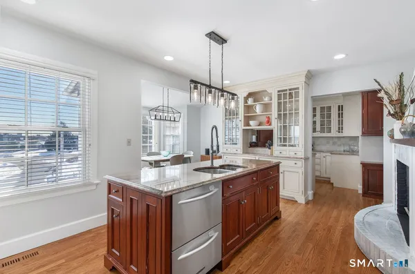 a kitchen with stainless steel appliances granite countertop a stove and a wooden floors
