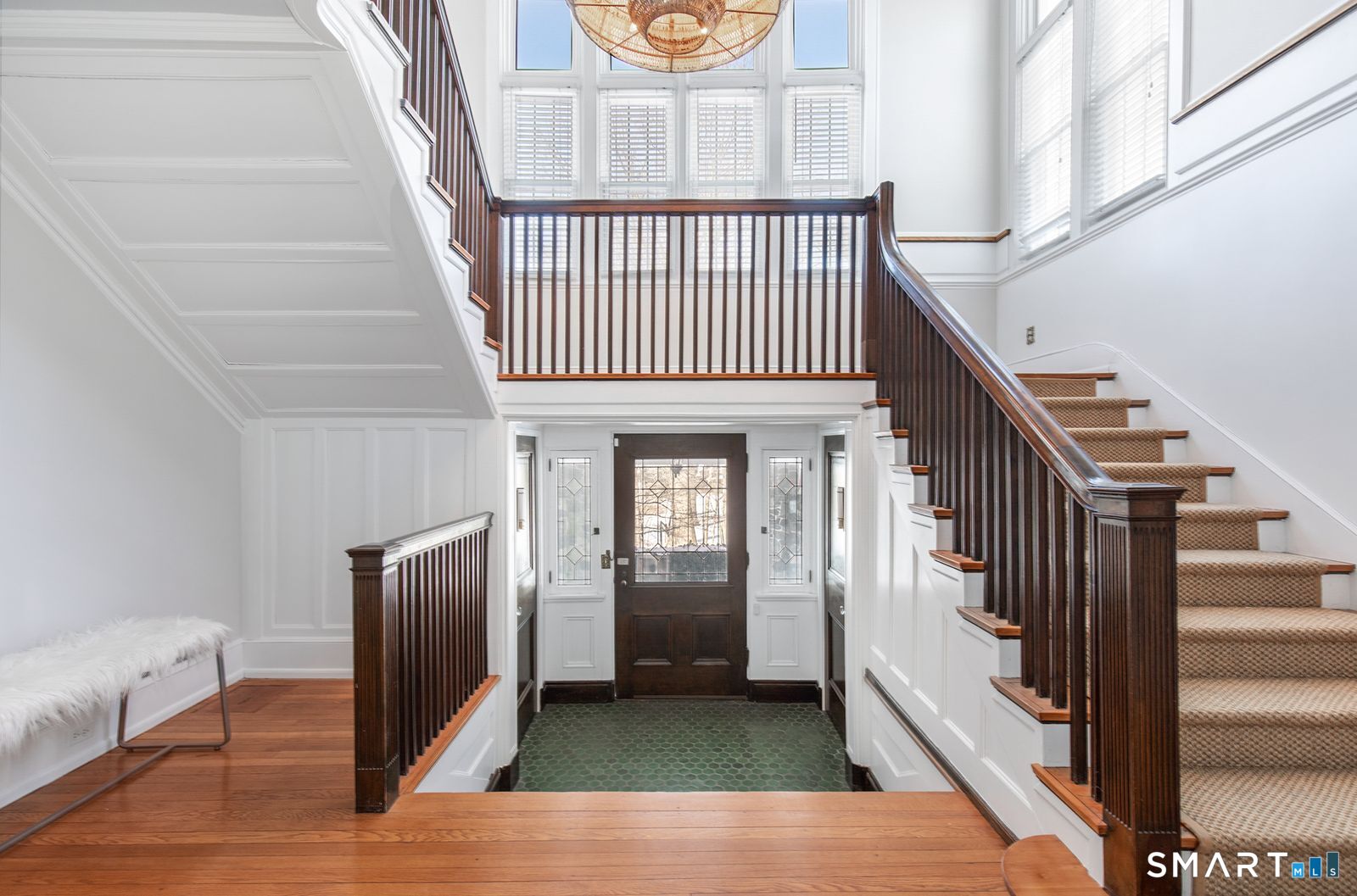 35 Point Lookout Milford, CT 06460 - Photo 10 of 31 A grand, light-filled foyer showcasing classic craftsmanship, featuring a dramatic split staircase