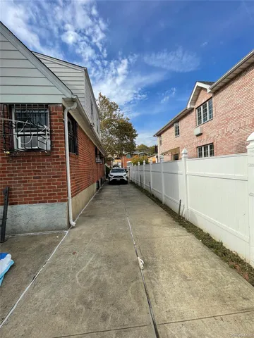 a view of a parking space in a backyard of a house