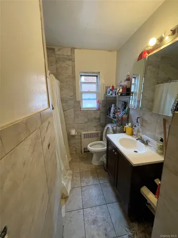 a bathroom with a sink a toilet and mirror