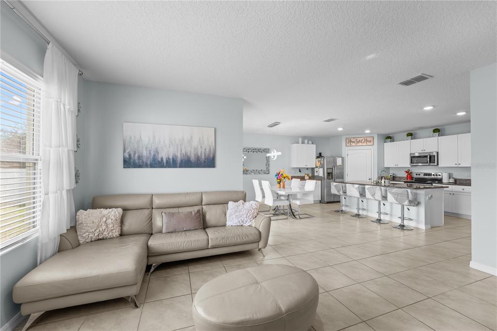 1833 Bluepoint Street St. Cloud, FL 34771 - Photo 18 of 46 a living room with furniture and kitchen view