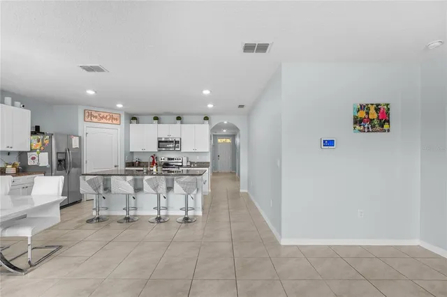 a view of kitchen with furniture and refrigerator