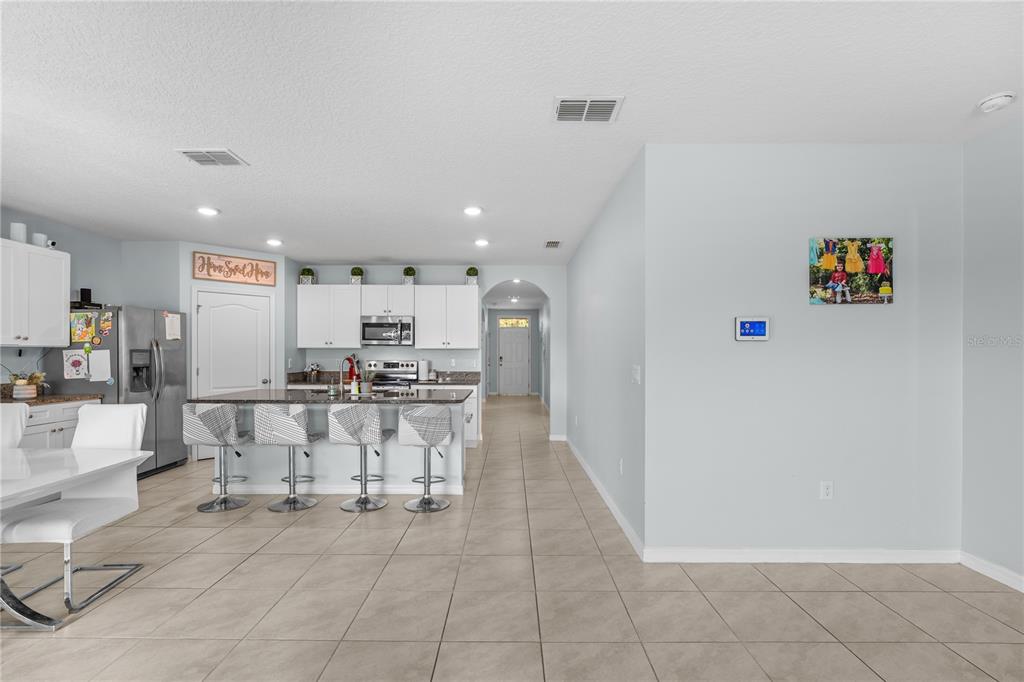 1833 Bluepoint Street St. Cloud, FL 34771 - Photo 19 of 46 a view of kitchen with furniture and refrigerator