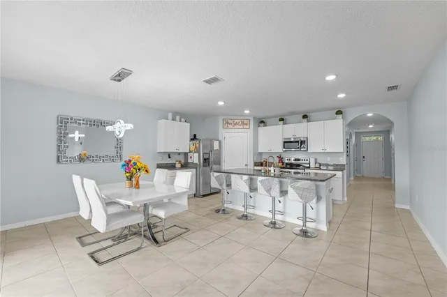 a living room with furniture a air conditioner and a table