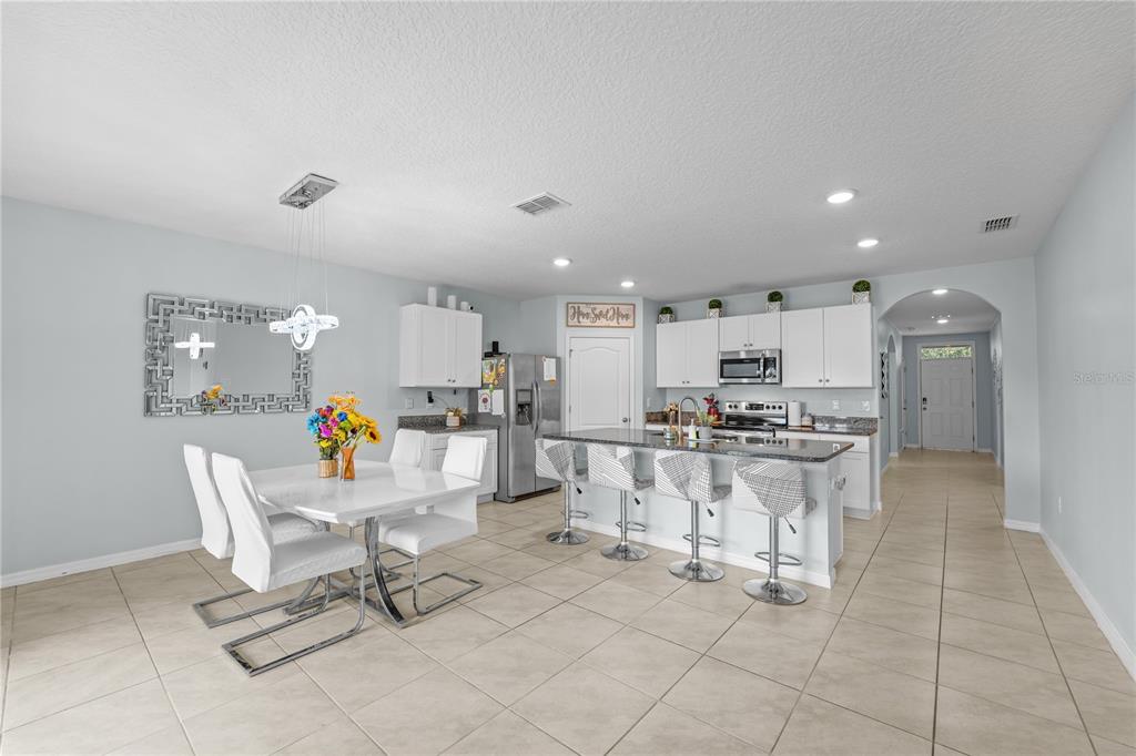 1833 Bluepoint Street St. Cloud, FL 34771 - Photo 20 of 46 a living room with furniture a air conditioner and a table