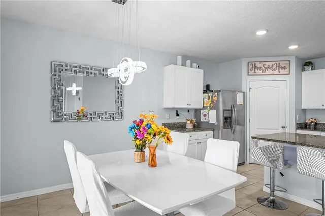 a dining room with furniture and chandelier