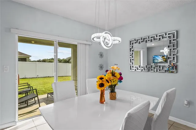 a dining room with furniture and a window