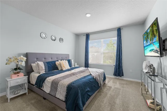 a bed sitting in a bedroom next to a window