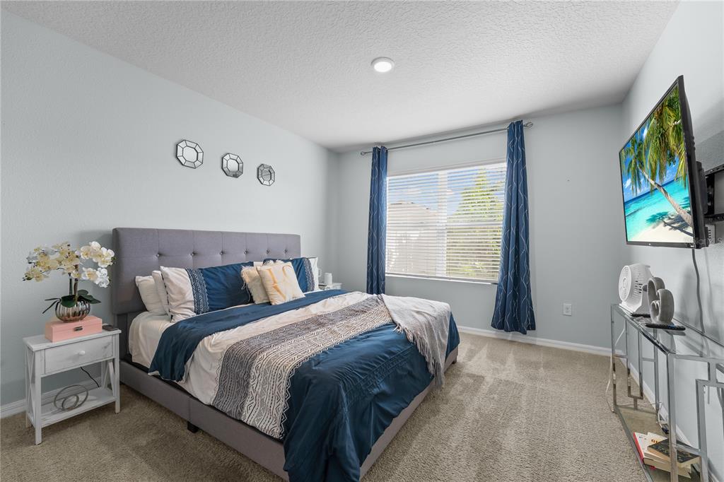 1833 Bluepoint Street St. Cloud, FL 34771 - Photo 30 of 46 a bed sitting in a bedroom next to a window