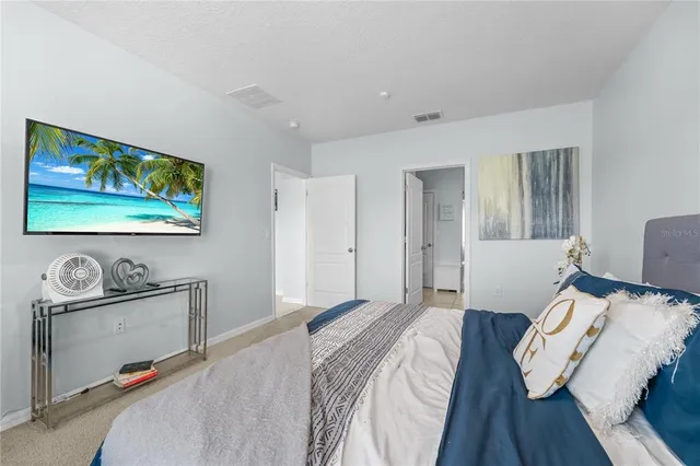 a bedroom with bed and wooden floor