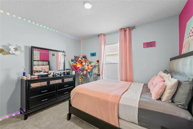 a bedroom with a bed and a mirror