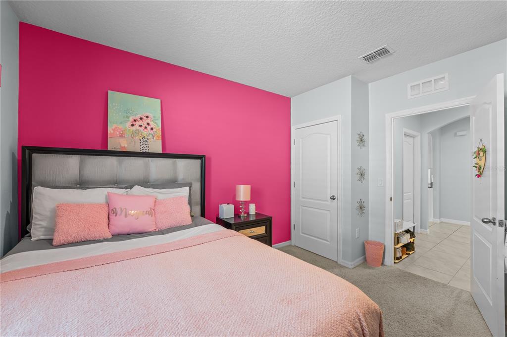 1833 Bluepoint Street St. Cloud, FL 34771 - Photo 36 of 46 a bedroom with a bed and a mirror