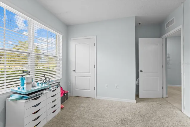 a bathroom with a granite countertop sink a toilet and a mirror