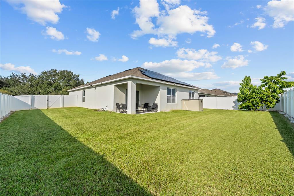 1833 Bluepoint Street St. Cloud, FL 34771 - Photo 45 of 46 a backyard of a house with lots of green space