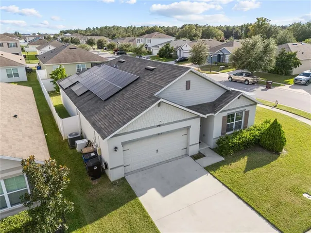 an aerial view of a house with a yard