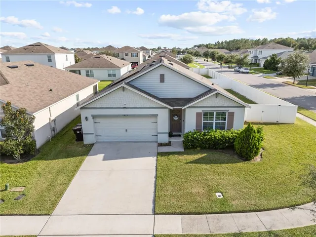 a aerial view of a house with a yard