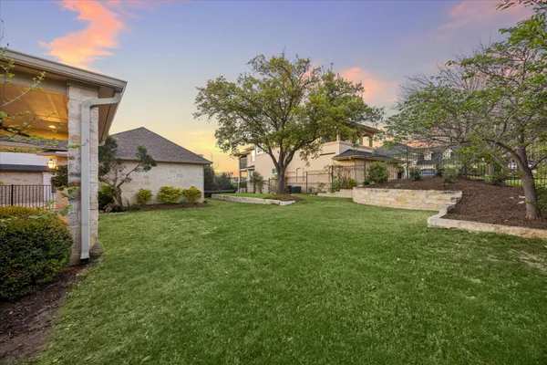 a view of a house with backyard and sitting area