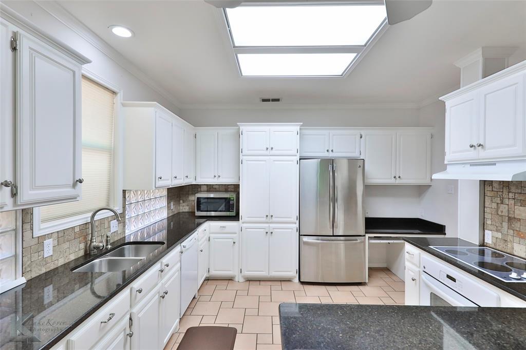 106 Riverside Park Abilene, TX 79605 - Photo 11 of 40 a kitchen with granite countertop a refrigerator stove and sink