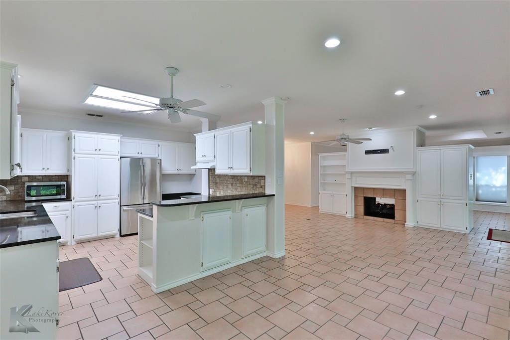 106 Riverside Park Abilene, TX 79605 - Photo 14 of 40 a kitchen with cabinets and chairs