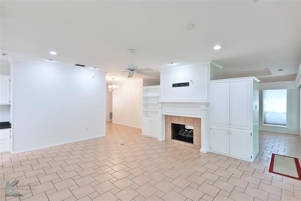 106 Riverside Park Abilene, TX 79605 - Photo 19 of 40 an empty room with fireplace and wooden cabinet