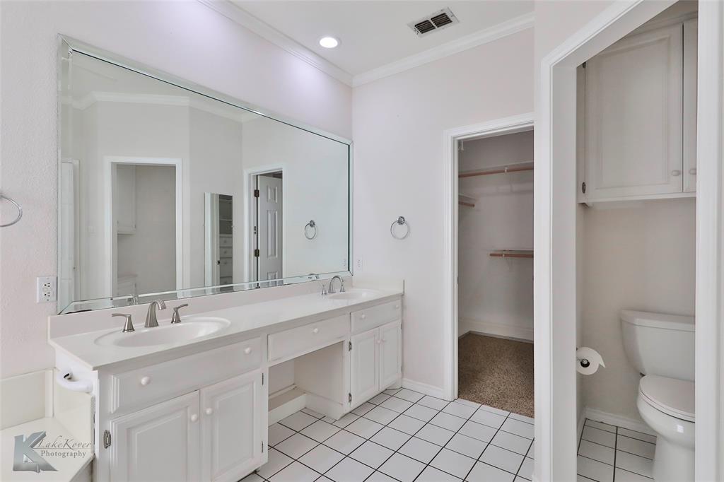 106 Riverside Park Abilene, TX 79605 - Photo 20 of 40 a spacious bathroom with a double vanity sink toilet mirror and a shower