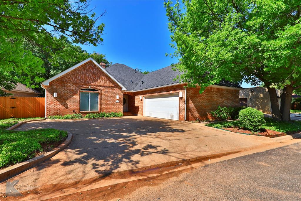 106 Riverside Park Abilene, TX 79605 - Photo 2 of 40 a front view of a house with a yard and garage