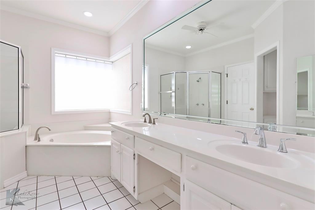 106 Riverside Park Abilene, TX 79605 - Photo 22 of 40 a bathroom with a sink double vanity mirror and a bathtub