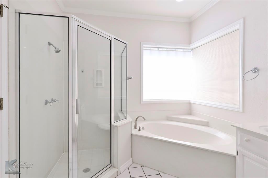 106 Riverside Park Abilene, TX 79605 - Photo 23 of 40 a bathroom with a bathtub and a shower